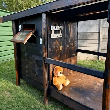 Raised bed and café corner details of a timber K9 cabin at golden hour